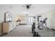 Spacious bonus room featuring exercise equipment, a bedroom area, and ample natural light at 447 Willow Pond Ln, Hiddenite, NC 28636