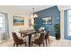 Bright dining room featuring modern lighting, an elegant table, and contemporary art at 447 Willow Pond Ln, Hiddenite, NC 28636