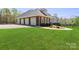 Brick home with a manicured lawn, mature trees, and a spacious four-car garage at 447 Willow Pond Ln, Hiddenite, NC 28636