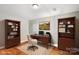 Home office with built-in bookshelves, a wooden desk, and a comfortable chair for remote work at 447 Willow Pond Ln, Hiddenite, NC 28636