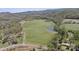 Aerial view showcasing a vast property featuring a pond and verdant open fields, surrounded by tree lined property lines at 447 Willow Pond Ln, Hiddenite, NC 28636