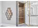 Glass shower with shelving and gray tile at 447 Willow Pond Ln, Hiddenite, NC 28636