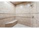Neutral tiled shower featuring a shower head, bench and tile border at 447 Willow Pond Ln, Hiddenite, NC 28636