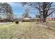 A charming one-story brick home nestled within a well-maintained lawn and a mature tree canopy at 4601 Mendham Dr, Charlotte, NC 28215