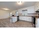 The kitchen features white cabinets, stainless steel appliances, and hardwood floors at 4601 Mendham Dr, Charlotte, NC 28215