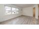 A sunlit living room featuring new floors and a large window overlooking the neighborhood at 4601 Mendham Dr, Charlotte, NC 28215