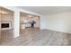 Open-concept living room, showcasing the seamless transition to the kitchen and a cozy fireplace at 4601 Mendham Dr, Charlotte, NC 28215