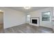 Bright living room featuring hardwood floors and a cozy white-brick fireplace at 4601 Mendham Dr, Charlotte, NC 28215