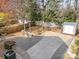 Backyard features a stone patio with a fire pit, storage shed, and landscaping at 4741 Eaves Ln, Charlotte, NC 28215