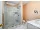 Modern bathroom with a glass-enclosed shower featuring marble-look tile, and a sleek vanity at 4741 Eaves Ln, Charlotte, NC 28215