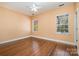 Bright bedroom with hardwood floors, two large windows, and a ceiling fan at 4741 Eaves Ln, Charlotte, NC 28215