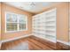 Bedroom with hardwood floors and a large built-in bookcase next to a window with lots of natural light at 4741 Eaves Ln, Charlotte, NC 28215