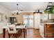 Bright dining area features a modern chandelier, table with seating for six, and access to the kitchen at 4741 Eaves Ln, Charlotte, NC 28215