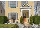 Inviting front porch with decorative features, including lush greenery and white rock landscaping at 4741 Eaves Ln, Charlotte, NC 28215