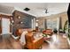 Cozy living room featuring hardwood floors, stylish leather furniture, and modern decor at 4741 Eaves Ln, Charlotte, NC 28215