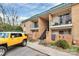 Exterior building facade with yellow vehicle on the foreground, lush landscaping, and brick accents at 4743 Hedgemore Dr # E, Charlotte, NC 28209