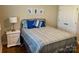 Comfortable bedroom featuring a bed with blue and white bedding, and decorative wall art at 6111 Gold Springs Way, Denver, NC 28037