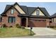 Inviting brick home with a two-car garage, manicured lawn, and classic architectural details at 6111 Gold Springs Way, Denver, NC 28037