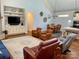 Spacious living room features a vaulted ceiling, a built-in entertainment center, and hardwood floors at 6111 Gold Springs Way, Denver, NC 28037