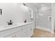 Bright bathroom featuring a double vanity, modern fixtures, and a glass-enclosed shower with marble tiling at 615 W Stanly W St, Stanfield, NC 28163