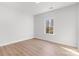 This bedroom has wood-look flooring, a window, and neutral colors, perfect for a minimalist lifestyle at 615 W Stanly W St, Stanfield, NC 28163