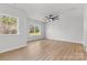 Bright bedroom features wood-look floors, two windows, a ceiling fan, and neutral paint at 615 W Stanly W St, Stanfield, NC 28163