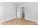 Minimalist bedroom with light wood-look flooring and a white door offers a serene and inviting space at 615 W Stanly W St, Stanfield, NC 28163