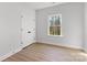 Neutral bedroom with a window and wood-look flooring; perfect for rest and relaxation at 615 W Stanly W St, Stanfield, NC 28163