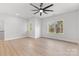 Spacious bedroom features wood-look floors, two windows, a ceiling fan, and neutral paint at 615 W Stanly W St, Stanfield, NC 28163