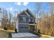 Charming two-story house featuring blue siding, a gray two-car garage, and a driveway leading up to the home at 615 W Stanly W St, Stanfield, NC 28163