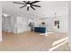 Open kitchen featuring a blue island, modern light fixtures, white cabinets, and stainless steel appliances at 615 W Stanly W St, Stanfield, NC 28163