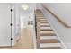 Elegant staircase featuring wood treads and a white risers, leading to the upper level with wood floors at 615 W Stanly W St, Stanfield, NC 28163