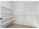 Walk-in closet features wood-look floors, built-in shelving, and neutral paint at 615 W Stanly W St, Stanfield, NC 28163