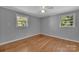 Bedroom with wood floors, neutral walls, a ceiling fan, and natural light from two windows at 647 Black E St, Rock Hill, SC 29730