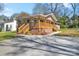 A charming one-story home showcasing a spacious driveway and inviting wooden deck at 647 Black E St, Rock Hill, SC 29730