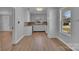 Bright kitchen featuring white cabinets, plank flooring, and stainless sink at 647 Black E St, Rock Hill, SC 29730