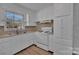 A bright kitchen featuring white cabinets, countertops and flooring at 647 Black E St, Rock Hill, SC 29730