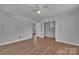 Bright living room with wood-look floors has neutral walls and white ceiling leading to other rooms at 647 Black E St, Rock Hill, SC 29730