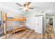 Bedroom with a bunkbed, wood-look floors, ceiling fan, and closet at 7360 Winery Ln, Charlotte, NC 28227