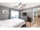 Gray bedroom with ceiling fan, neutral bedding, wood floors and access to outdoor patio at 7360 Winery Ln, Charlotte, NC 28227