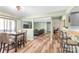 Open floor plan view of dining area with wood floors and access to kitchen, living room and sunroom at 7360 Winery Ln, Charlotte, NC 28227