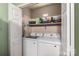 Spacious laundry room with washer, dryer, shelving for storage and an ironing board at 7360 Winery Ln, Charlotte, NC 28227