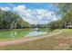 Scenic community pond with a fountain and walking path, enhancing the neighborhood's appeal at 7360 Winery Ln, Charlotte, NC 28227