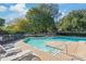 Community pool area featuring multiple pools, lounge chairs, and mature shade trees at 7360 Winery Ln, Charlotte, NC 28227