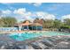 Community pool featuring lounge chairs, covered area, and lush greenery at 7360 Winery Ln, Charlotte, NC 28227