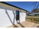 Inviting back porch boasts new wooden planks and classic white siding to welcome you home at 1018 Union St, Maiden, NC 28650
