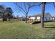 Backyard view showcases the new wooden porch, mature trees, and a generous lawn at 1018 Union St, Maiden, NC 28650