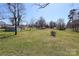Expansive backyard with mature trees and a lush lawn provides ample space for outdoor enjoyment at 1018 Union St, Maiden, NC 28650