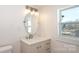 Bathroom vanity with white countertops, modern fixtures, and a window for natural light at 1018 Union St, Maiden, NC 28650