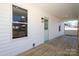 View of the covered front porch with wood decking, a light fixture, and a pale blue front door at 1018 Union St, Maiden, NC 28650